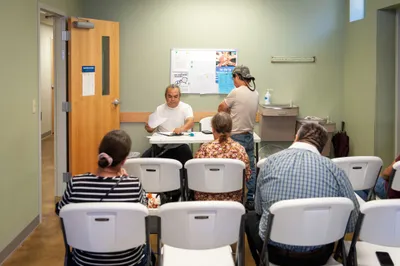 Volunteer Eddie Garcia, left, takes down patient information at a medical clinic provided free of charge to local residents in Hope, Ark. on Sept. 7, 2023. Photo by Rory Doyle.